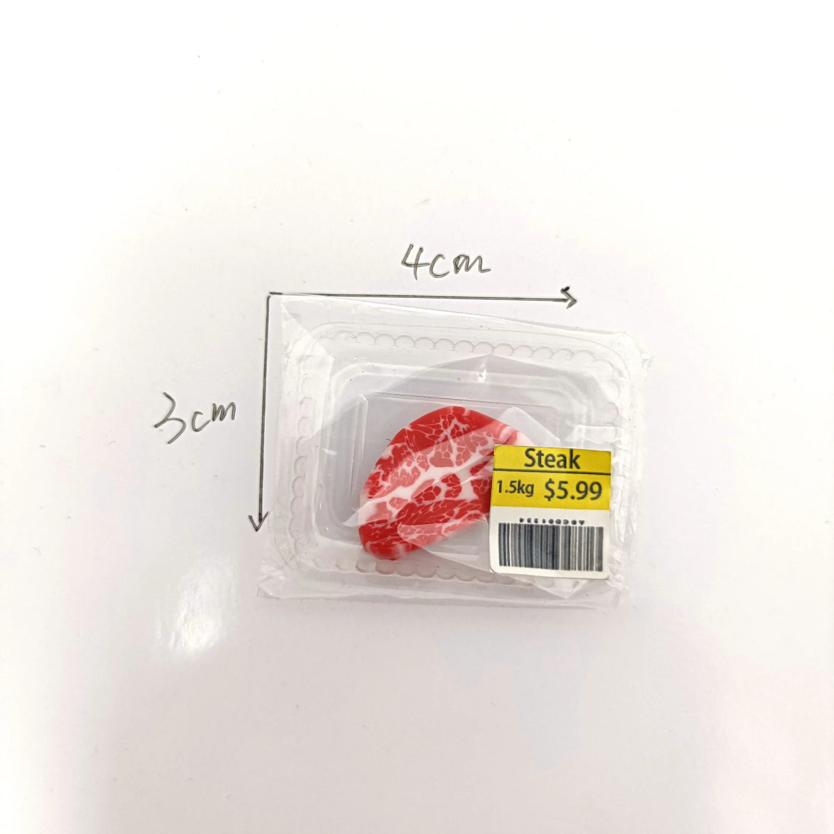 A package containing a realistic cut of steak, labeled as 1.5kg for $5.99.