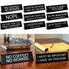 A collection of black desk signs with humorous phrases like NO COFFEE NO WORKEE and I MUST BE IMPORTANT.