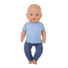 A baby doll wearing a light blue unicorn pajama set with dark blue pants and feet.