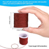 A hand holds a spool of reddish-brown nylon knotting cord for jewelry making, showing its size and texture.