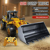 A yellow dump truck remote control vehicle with a silver bucket and dump tray is shown on a textured surface.