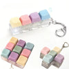 A clear silicone keyboard fidget toy featuring pastel colored keys and a metal keychain.