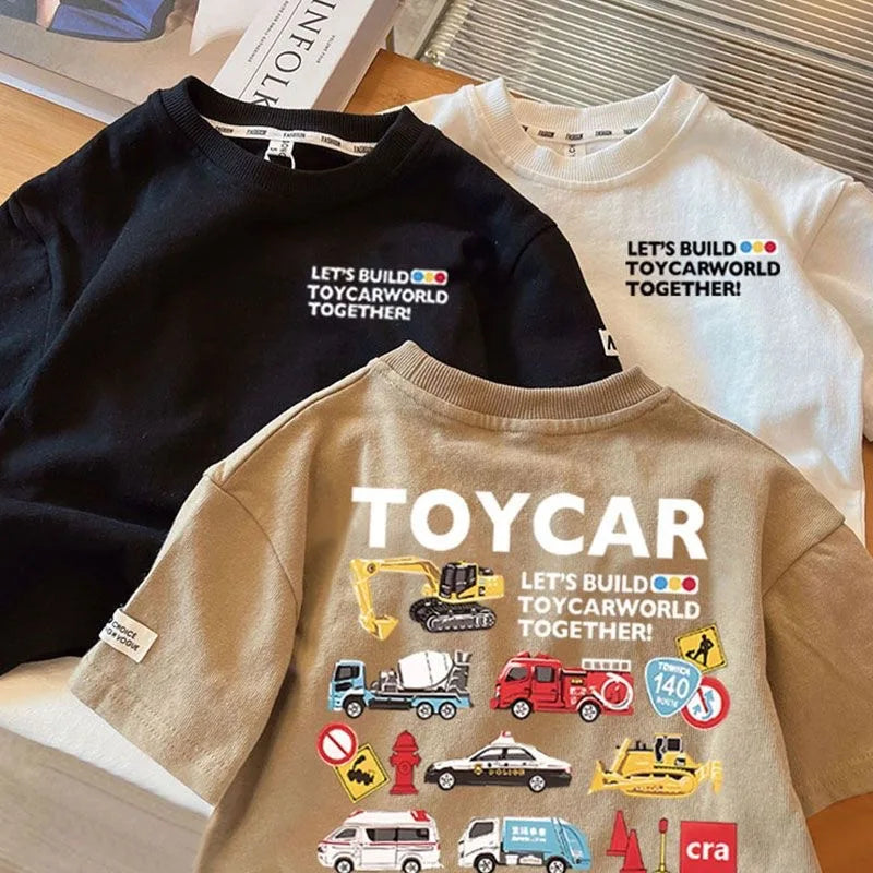 A beige crew neck t-shirt featuring a yellow toy car graphic and text encouraging kids to build toycarworld together.
