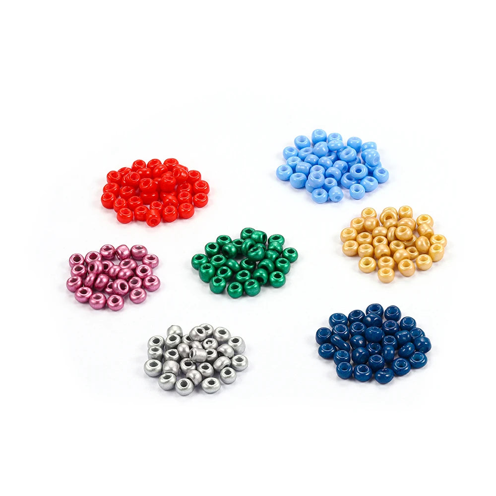 A collection of loose round glass seed beads in various colors including red, blue, green, purple, and gold.