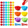 A colorful set of pom-poms in various colors and sizes for counting and sorting toddlers includes bowls and tools.