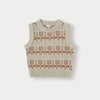 A beige knit sweater and pants set for a toddler, featuring a repeating floral pattern.
