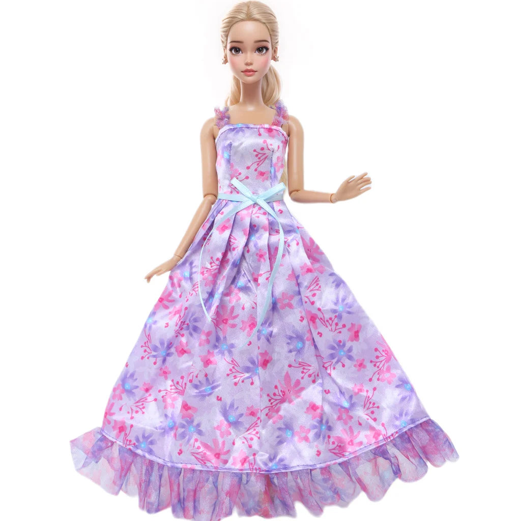 A female doll wearing a purple floral evening gown with pink accents and a light blue sash.