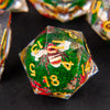 A green polyhedral die with a bee design and numbers is shown on a dark surface.