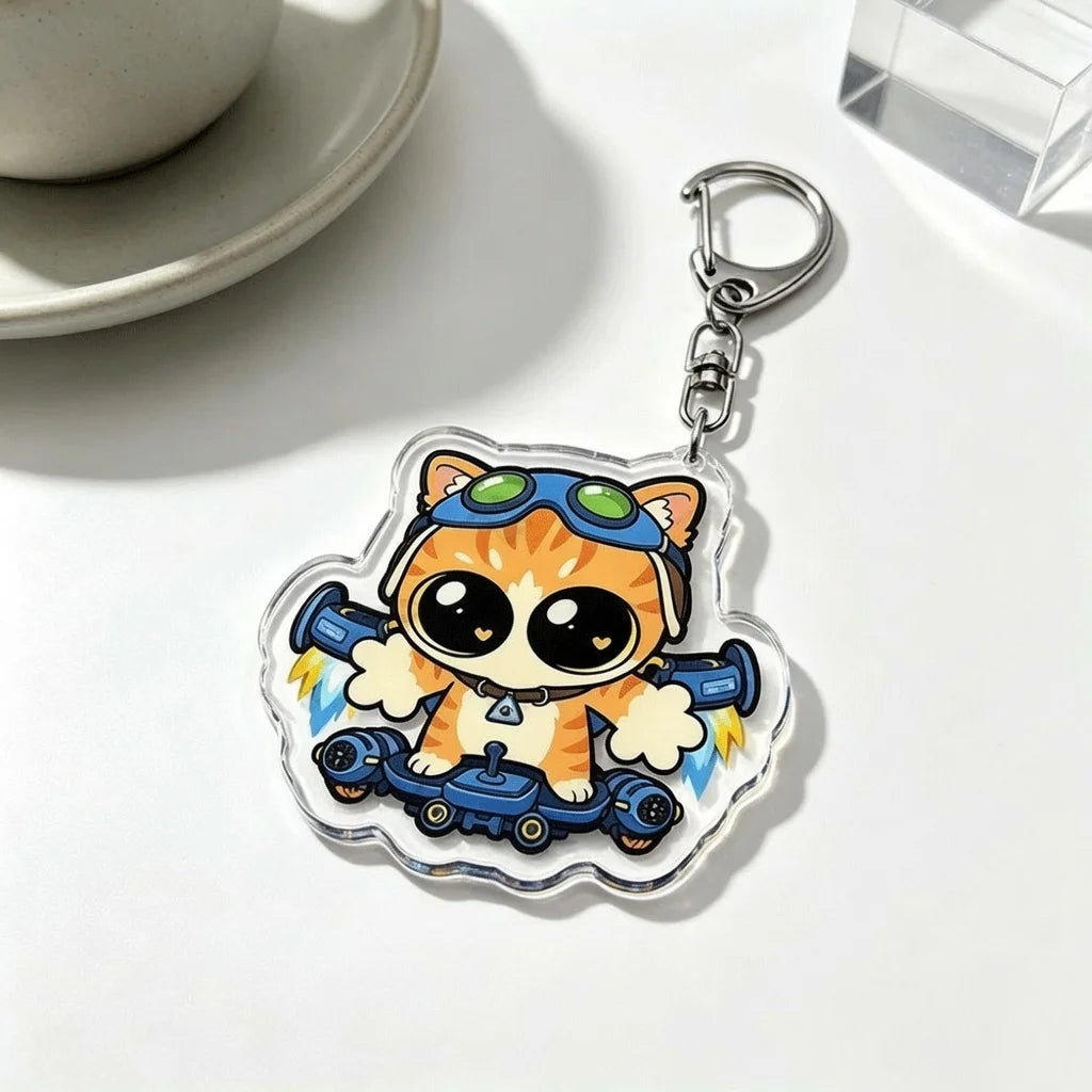 An acrylic keychain charm featuring an orange cat wearing blue goggles and riding a blue vehicle.