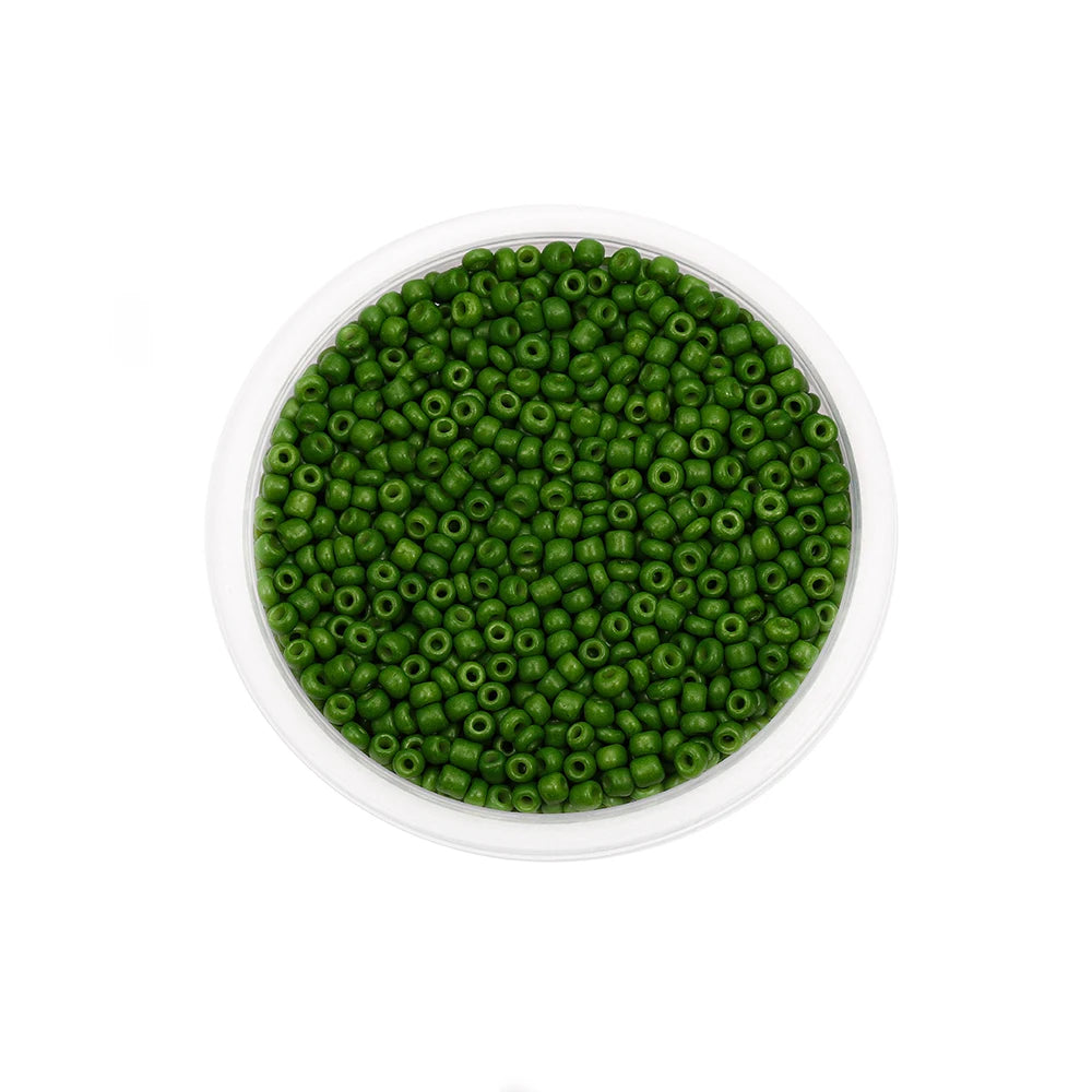 A clear container filled with small, round, green glass seed beads for jewelry making.