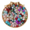 A collection of colorful 8mm glass crackle beads in various shades and sizes displayed in a gold-toned dish.