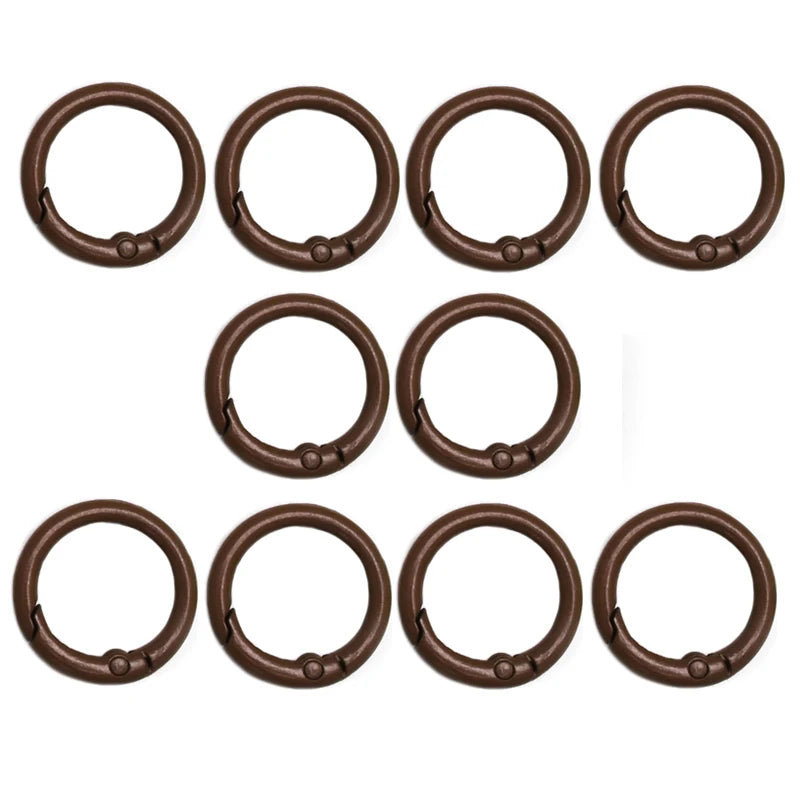 A set of eight bronze-colored alloy snap hook keychain clips arranged in a row.