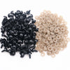 A pile of black plastic safety eyes and a pile of beige plastic eye washers.