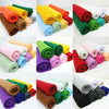 A collection of rolled soft felt fabric sheets in various colors including orange, yellow, green, red, purple, and gray.