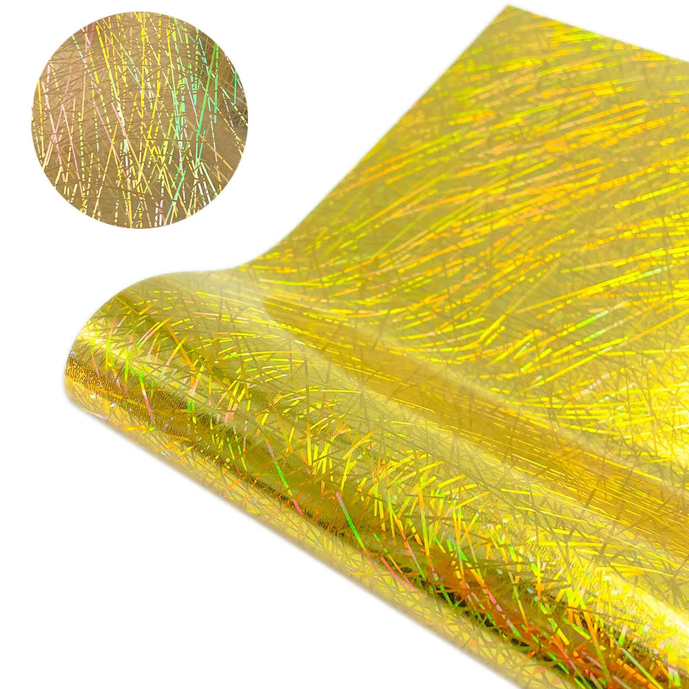 A close-up of holographic glitter heat transfer vinyl sheet showing iridescent gold and green fibers.