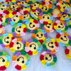 A collection of handmade crochet sunflower decorative smile orbs in various bright colors
