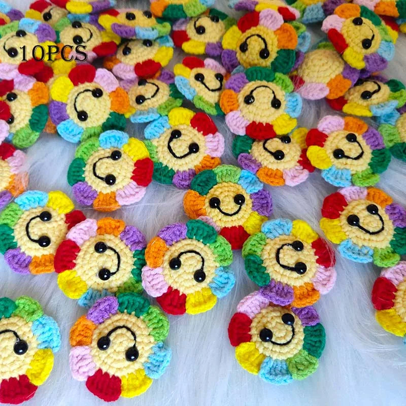 A collection of handmade crochet sunflower decorative smile orbs in various bright colors