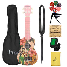 A ukulele starter kit featuring a pink body with a Hawaiian floral design, along with a black strap and tuner.