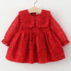 A red lace princess dress for a toddler girl featuring a doll collar and intricate eyelet embroidery.