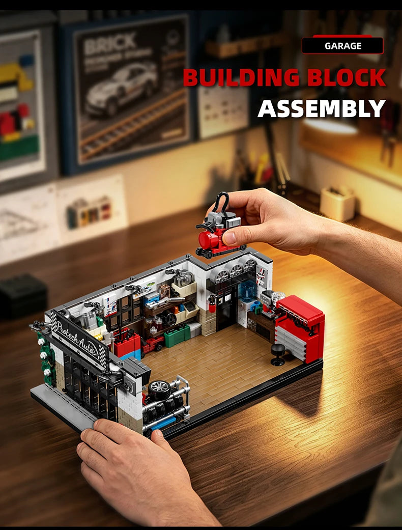 A hand is assembling a building block set depicting a vintage American garage scene with various miniature vehicles and tools