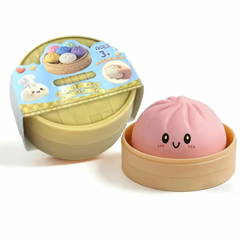A pink dumpling squishy stress ball is shown in a light brown steamer basket container.
