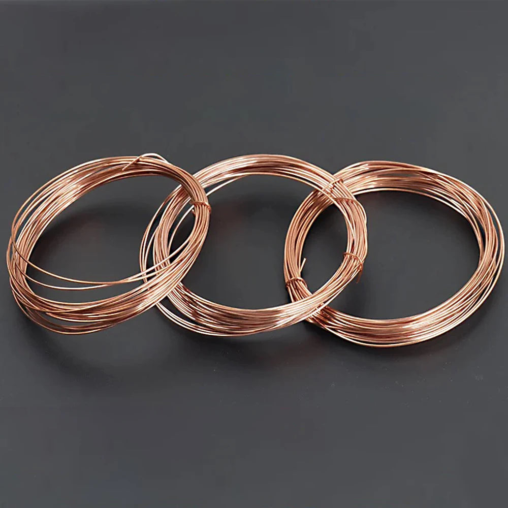 Three coils of solid bare copper wire demonstrating a twisted coil pattern.