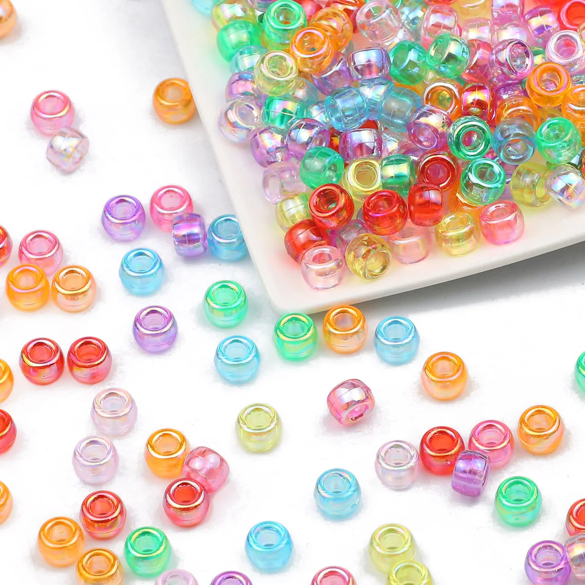 A pile of colorful pony beads in various shades including pink, green, yellow, and blue.