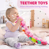 A baby is playing with a colorful, soft caterpillar plush toy designed for teething and sensory play.