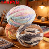 A pile of colorful, fluffy chenille yarn balls used for hand knitting projects.