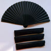 Elegant black folding hand fan with a bamboo frame shown in a fan shape and several flat folded sections.