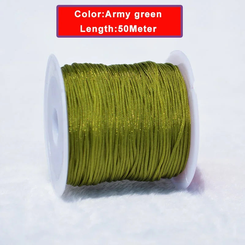A spool of 50 meter army green nylon knotting cord for jewelry making is shown on a white surface.