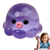 A purple octopus squishy stress ball with black eyes and a pink nose is shown next to a young child.