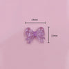 A pair of translucent purple acrylic bow beads shown with dimension lines.