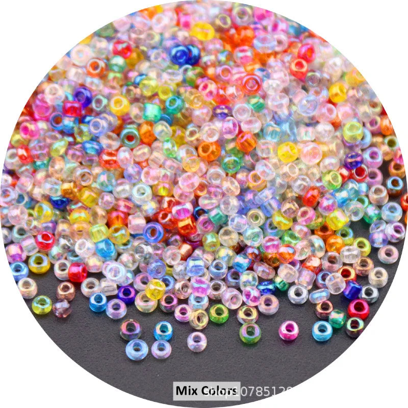 A close-up view of a mix of colorful round loose glass seed beads for jewelry making.