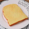 A slice of bread is placed on a white plate with text that reads GOOD MORNING.