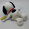 A white plush toy of Snoopy with black ears and a red collar, accompanied by a small tag.