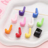 Colorful acrylic letter beads in various colors and shapes arranged on a white tray