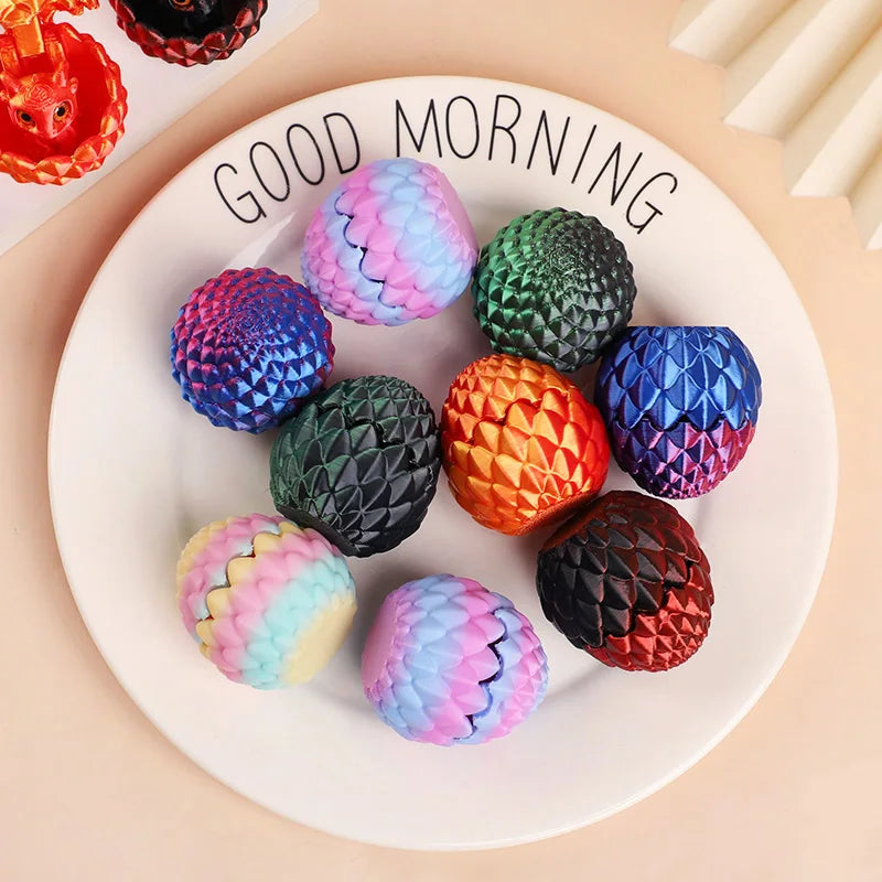 A white plate features six colorful, textured 3D dragon egg surprise figurines in various shades of purple, green, orange, an