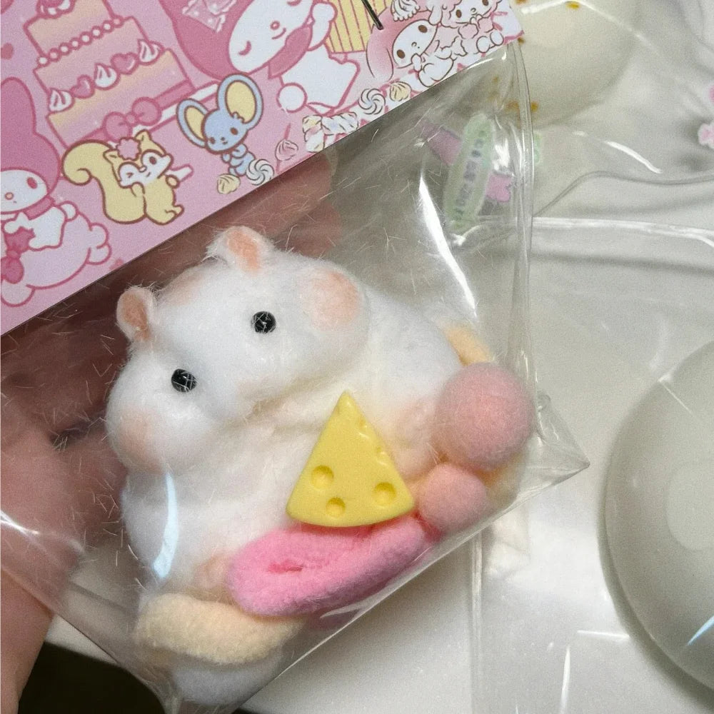 A white silicone hamster fidget toy with pink and yellow accents is sealed in a clear plastic bag.
