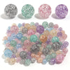 A collection of round loose glitter cracked acrylic beads in various colors including pink, purple, green, and silver.