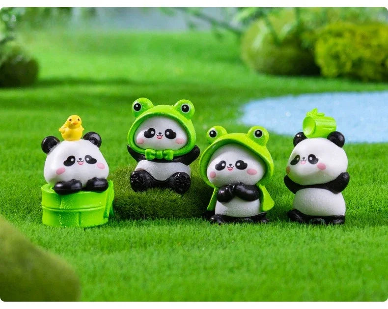 A set of adorable resin panda figurines in various poses and colors sitting on green grass.