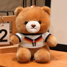 A fluffy brown teddy bear wearing a white and black football jersey with the number 11.