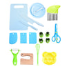 A set of safe plastic play knives and tools including a blue cutting board, various plastic knives, a yellow spatula, and gre