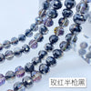 A close-up of a strand of dark gray and purple Austrian crystal beads with an AB coating.