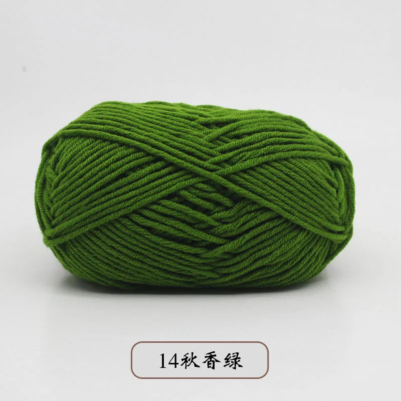 A ball of dark green pre-dyed milk cotton yarn used for knitting and crochet.