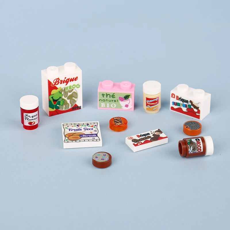 A collection of colorful Brigue building blocks shaped like food items including pizza, cake, and peanut bricks.