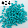 A pile of 1000 small, cylindrical fuse beads in various shades of teal and blue.