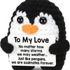 Black and white penguin plush toy with a sign that reads To My Love