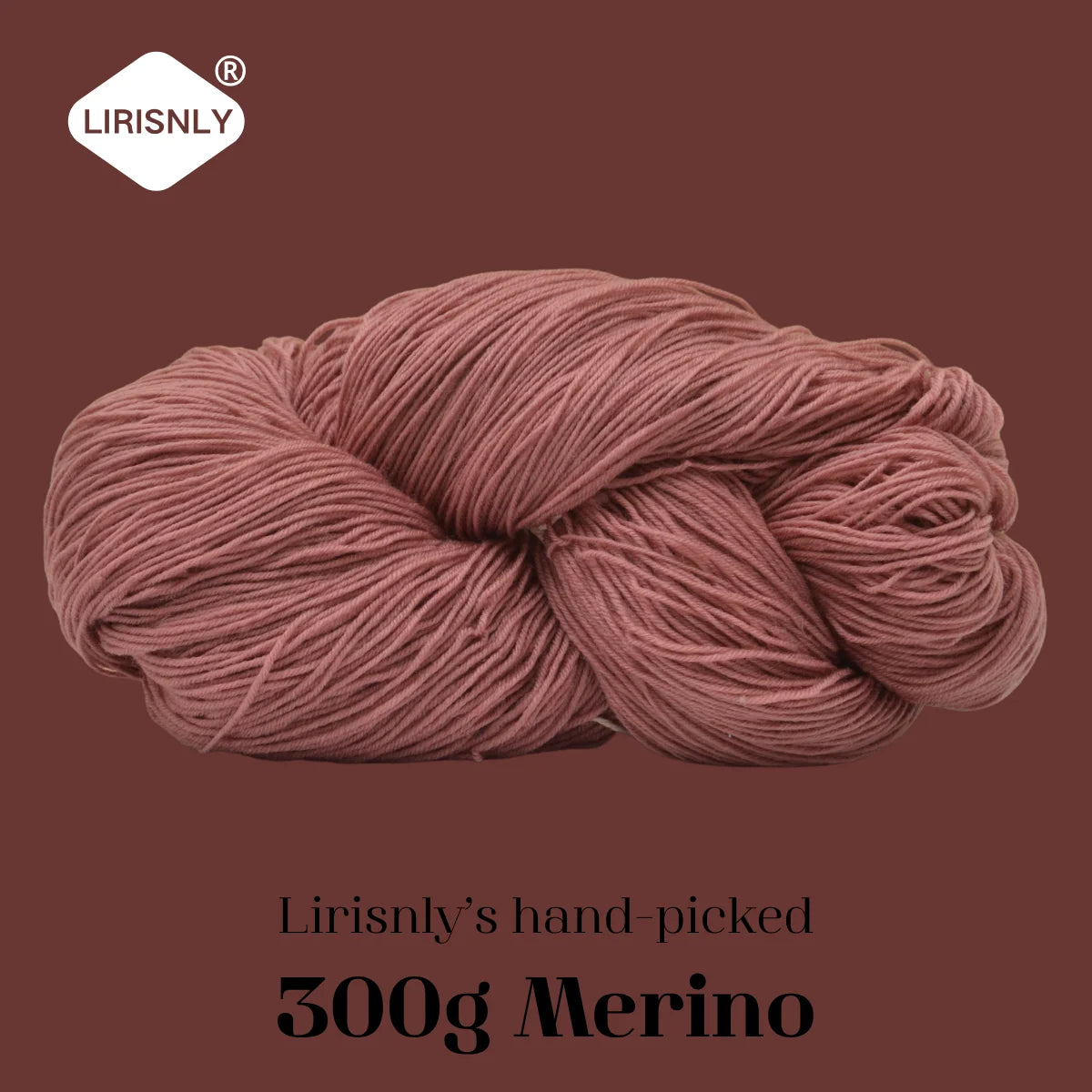 A ball of reddish-pink merino wool yarn labeled as Lirisnly's hand-picked 300g Merino.