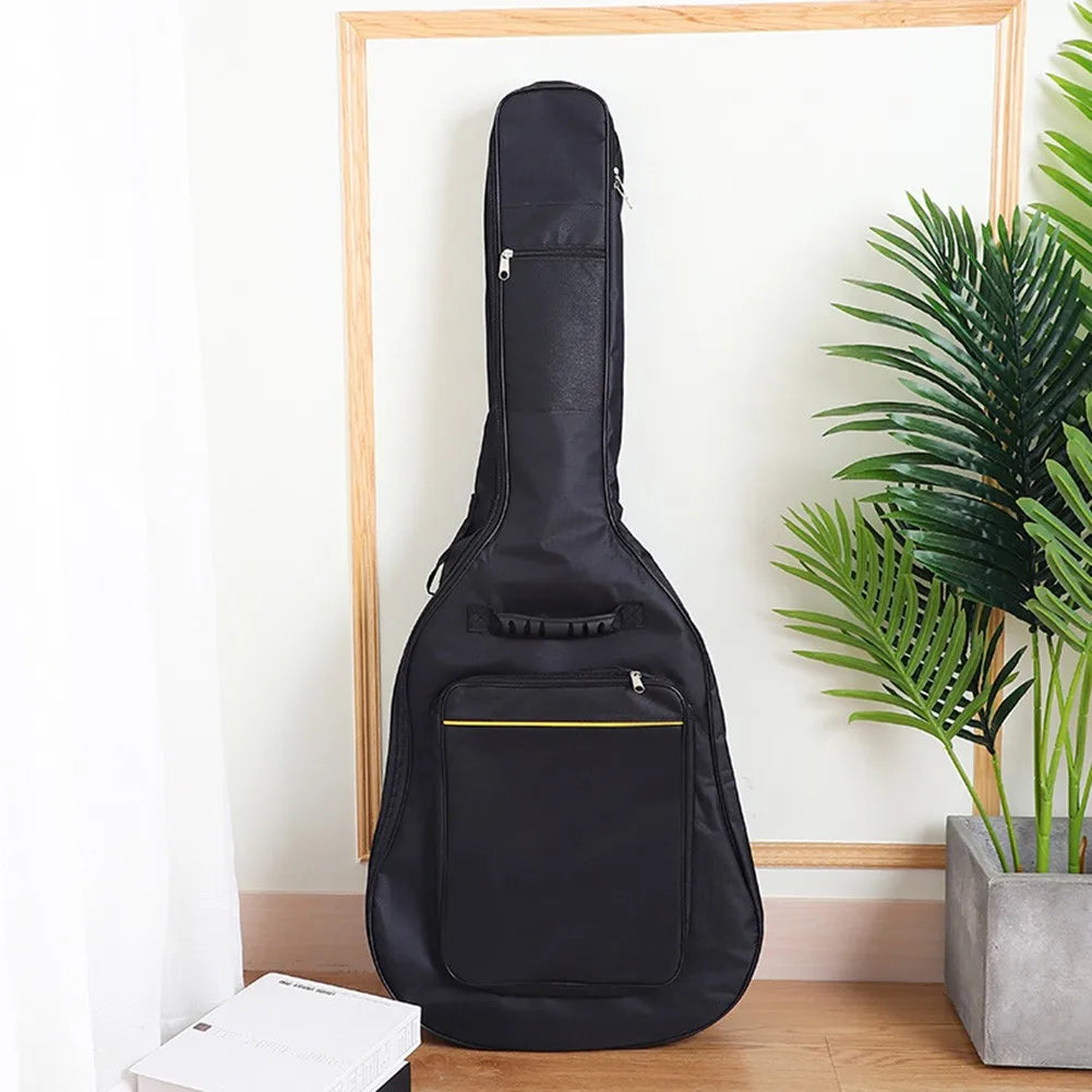 Black padded water-resistant guitar bag hanging in a wooden frame against a white wall.